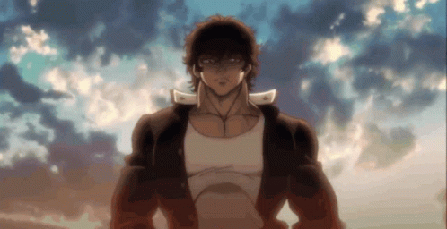 A Man In A White Tank Top Stands In Front Of A Blue Sky GIF