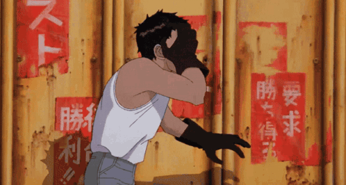 A Man In A White Tank Top Stands In Front Of A Yellow Wall With Chinese Writing On It GIF