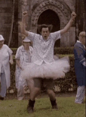A Man In A White Tutu Is Dancing In A Park GIF