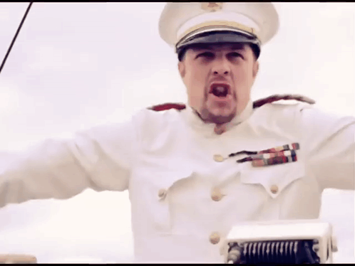 A Man In A White Uniform With A Hat And A Badge On His Chest GIF
