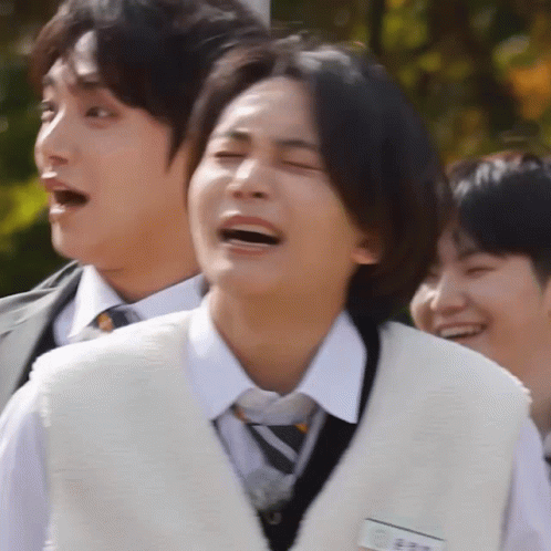 A Man In A White Vest And Tie Is Laughing GIF