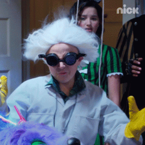 A Man In A White Wig And Goggles With The Nick Logo Behind Him GIF