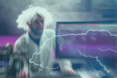 A Man In A White Wig Is Standing In Front Of A Computer Screen With Lightning Coming Out Of It GIF
