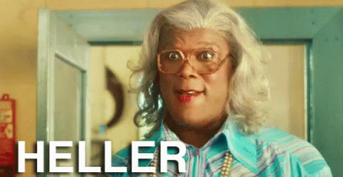 A Man In A Wig And Glasses Is Standing In Front Of A Door And The Word Heller Is On The Bottom GIF