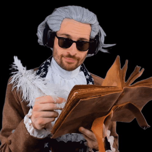 A Man In A Wig And Sunglasses Holds A Book GIF