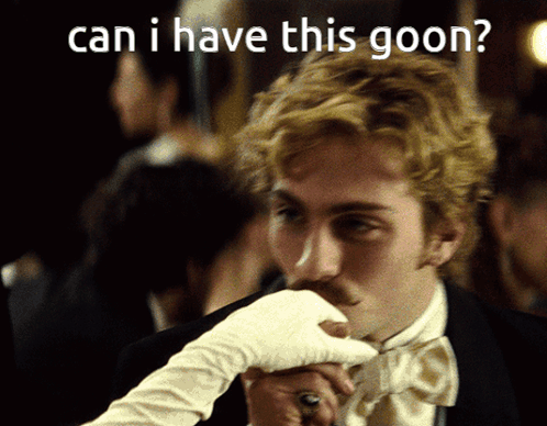 A Man In A Wig And Sunglasses Is Holding A Book GIF