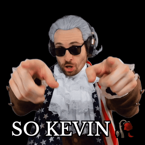 A Man In A Wig And Sunglasses Points At The Camera With The Words So Kevin Behind Him GIF