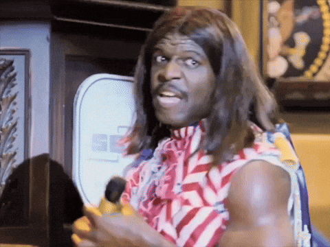 A Man In A Wig Is Holding A Banana In Front Of A Sign That Says Pepsi GIF