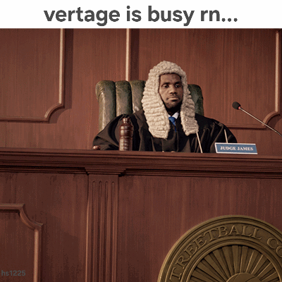 A Man In A Wig Sits In A Courtroom With The Words Vertage Is Busy Rn GIF