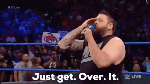 A Man In A Wrestling Ring Is Drinking From A Blue Cup . GIF