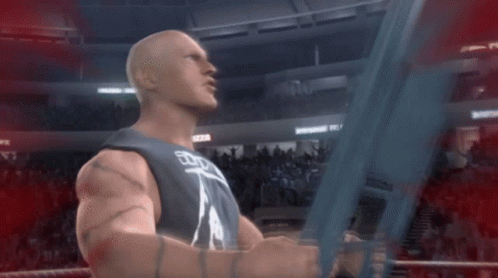 A Man In A Wrestling Ring Is Holding A Sword With The Word Wwe On It GIF