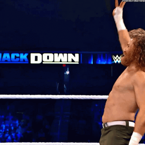 A Man In A Wrestling Ring With A Sign That Says ' Ck Down ' GIF