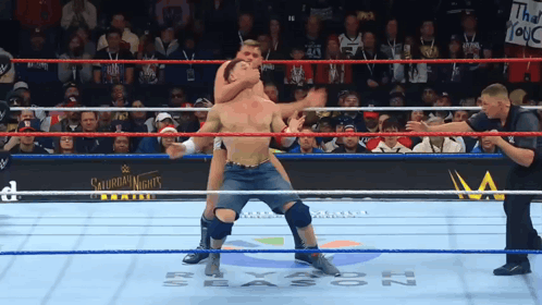 A Man In A Wrestling Ring With A Sign That Says Saturday Night 'S GIF