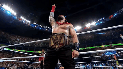 A Man In A Wrestling Ring With A W Belt On GIF