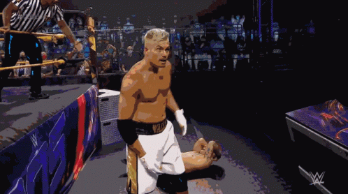 A Man In A Wrestling Ring With A W Logo On The Corner GIF
