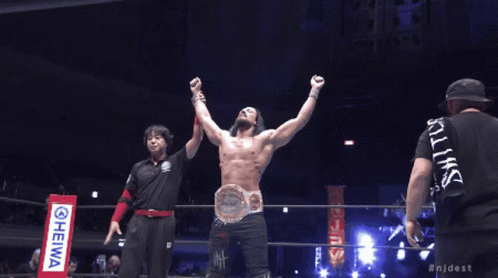 a man in a wrestling ring with his arms in the air and the hashtag njdest on the bottom