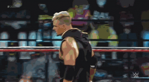 A Man In A Wrestling Ring With The Hashtag # 205Live In The Corner GIF
