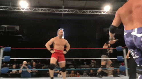 A Man In A Wrestling Ring With The Letter R On His Back GIF