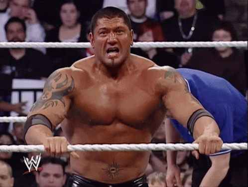 A Man In A Wrestling Ring With The Letter W On The Rope GIF