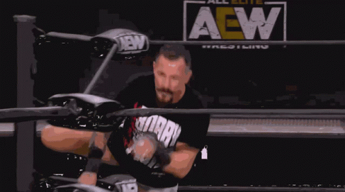 A Man In A Wrestling Ring With The Word All Elite Wrestling Behind Him GIF