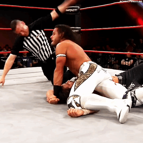 a man in a wrestling ring with the word impact on the side