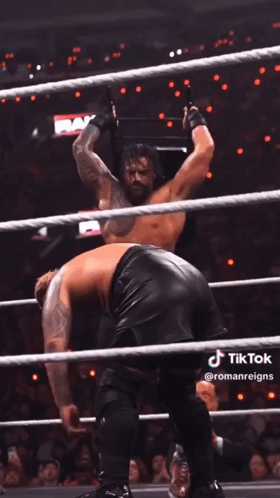 A Man In A Wrestling Ring With The Word Raw On The Wall Behind Him GIF
