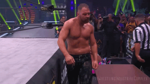 A Man In A Wrestling Ring With The Words Pro Wrestling Industrial Complex Written On The Bottom GIF