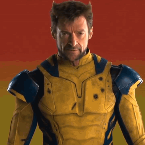 A Man In A Yellow And Blue Superhero Costume GIF