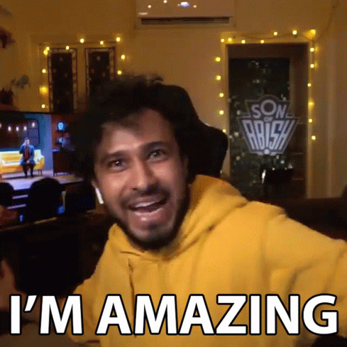 A Man In A Yellow Hoodie With The Words I 'M Amazing On The Bottom GIF