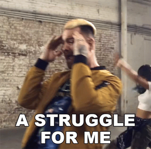 A Man In A Yellow Jacket Is Holding His Head And Says A Struggle For Me GIF