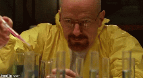 A Man In A Yellow Jacket Is Pouring Liquid Into Beakers GIF