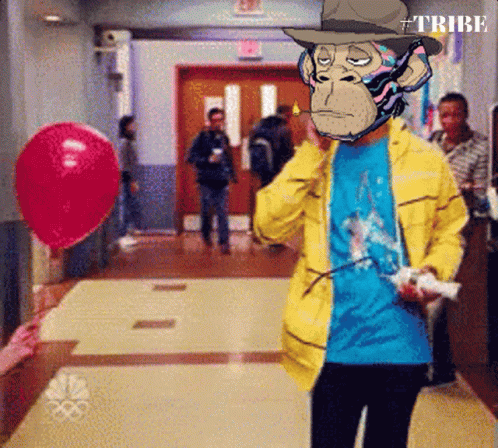 A Man In A Yellow Jacket With A Monkey On His Face Holding A Remote Control GIF