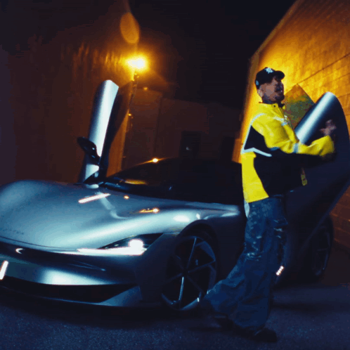 A Man In A Yellow Jacket With The Letter B On It GIF