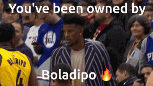 A Man In A Yellow Jersey With The Number 4 Stands In The Crowd GIF