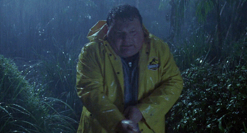 a man in a yellow jurassic park raincoat