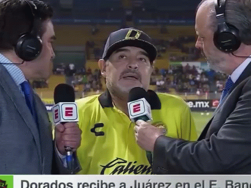 a man in a yellow palien shirt is being interviewed
