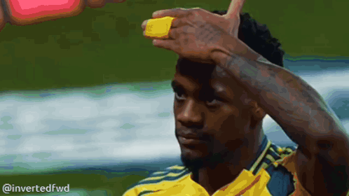 A Man In A Yellow Shirt Has A Yellow Band On His Forehead GIF