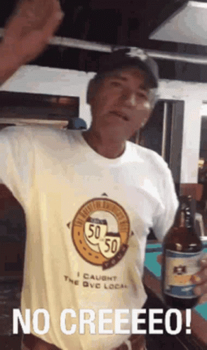 A Man In A Yellow Shirt Is Holding A Bottle Of Beer And Says No Creeeeeo ! GIF