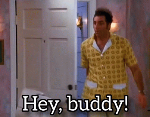A Man In A Yellow Shirt Is Standing In Front Of A Door And Says Hey Buddy GIF