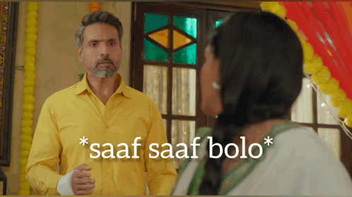 A Man In A Yellow Shirt Is Standing Next To A Woman With The Words Saaf Saaf Bolo On The Bottom GIF