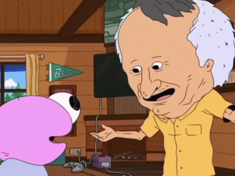 A Man In A Yellow Shirt Is Talking To A Cartoon Character In Front Of A Fireplace With A Banner That Says Boss GIF