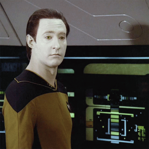 A Man In A Yellow Shirt Stands In Front Of A Screen That Says Science GIF