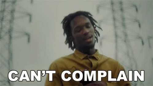 A Man In A Yellow Shirt With The Words Can 'T Complain Below Him GIF