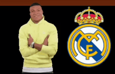 A Man In A Yellow Sweatshirt Stands Next To A Real Madrid Logo GIF