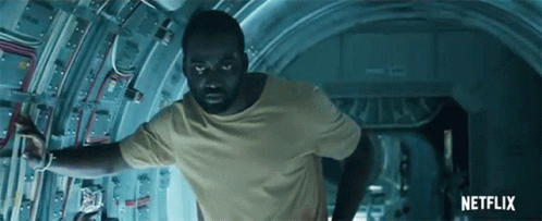 A Man In A Yellow T-Shirt Is Running Through A Tunnel With A Netflix Logo In The Background GIF