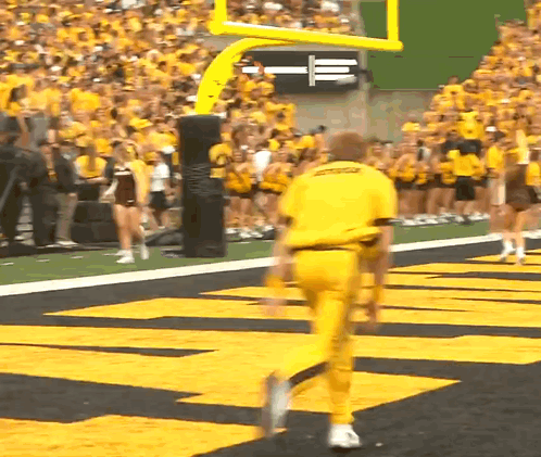 A Man In A Yellow Uniform That Says Ucsd On It GIF