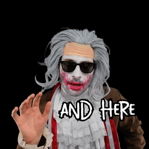 A Man In A Zombie Costume Says " And Here " With His Hand Outstretched GIF