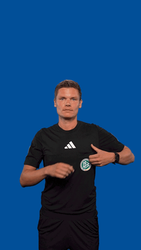 A Man In An Adidas Shirt Is Holding A Yellow Card GIF