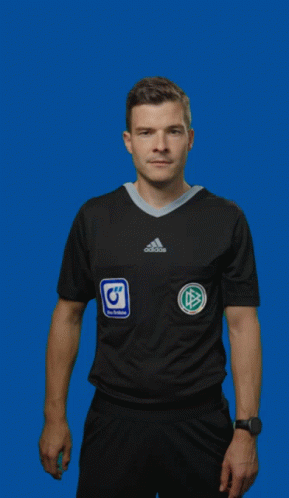 A Man In An Adidas Shirt Is Holding Up A Red Card GIF