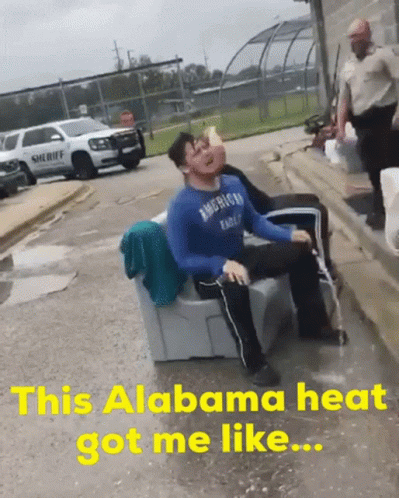 a man in an american eagle shirt is sitting on a couch in the rain